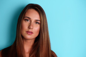 Naklejka premium Serious, confident young girl looking straight, isolated on blue background. Psychology, body language concept