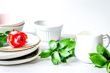 ceramic tableware with flowers on white background