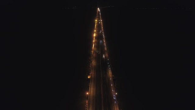 aerial view lighted bridge at night with highways and cars. suspension bridge over madura strait with highway and car, surabaya. aerial view bridge Suramadu connecting islands Java and Madura. High