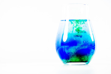a drop of paint in a jar of water