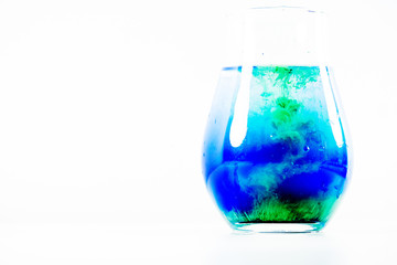 a drop of paint in a jar of water