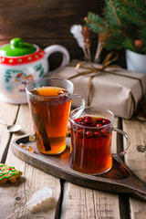 Two mugs of tea, Drink with rosehip, Christmas composition, home comfort, wooden background