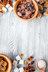 lumps of sugar in bowls on gray table background top view space 
