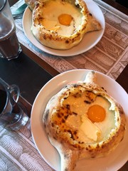 Delicious Georgian khachapuri pastry with egg and cheese