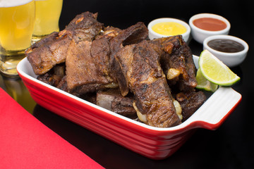 Fried pork rib in a black pub table