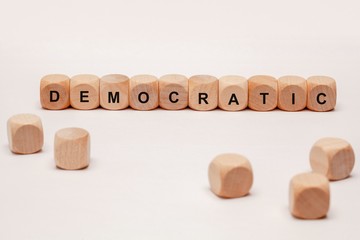 wooden cubes with letters. the word democratic is displayed, abstract illustration