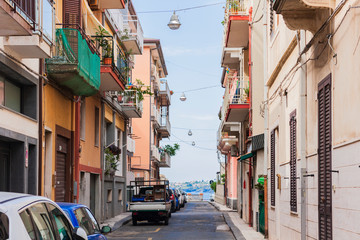 Fototapeta na wymiar Travel to Italy - historical street of Acitrezza, Catania, Sicily, ancient buildings