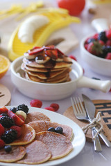 Pancakes served with many fresh fruits and berries