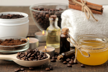 Fototapeta na wymiar homemade coffee scrub in a white jar for the face and body and various ingredients for making scrub. spa. cosmetics. care cosmetics