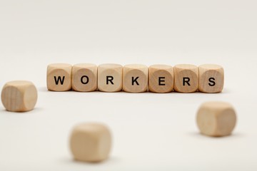 wooden cubes with letters. the word workers is displayed, abstract illustration