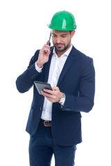 Young construction manager calling and using tablet isolated