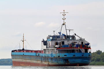 Old rusty ship in summer Danube river
