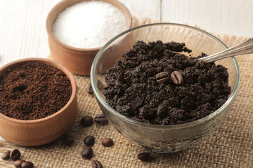 homemade coffee scrub in a jar for the face and body, and various ingredients for making scrub on a light background. spa. cosmetics. care cosmetics.