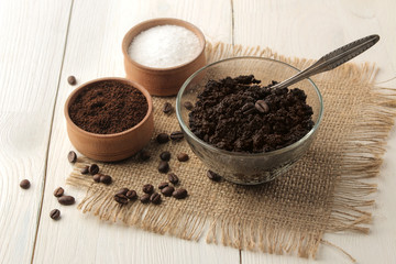 homemade coffee scrub in a jar for the face and body, and various ingredients for making scrub on a light background. spa. cosmetics. care cosmetics.