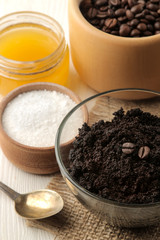 homemade coffee scrub in a jar for the face and body, and various ingredients for making scrub on a light background. spa. cosmetics. care cosmetics.