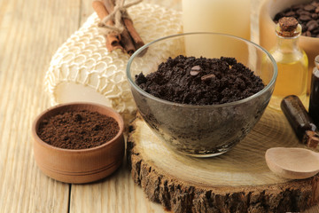 homemade coffee scrub in the face and body bowl and various ingredients for making scrub on a wooden table. spa. cosmetics. care cosmetics.