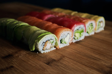 Various kinds of sushi served on wooden table