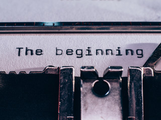 Old typewriter with text 'the beginning'