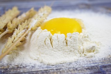 Prepare the dough for baking homemade cookies.Egg and flour on wooden background.