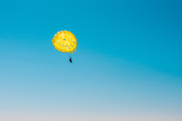 Free flight in the air on a yellow parachute