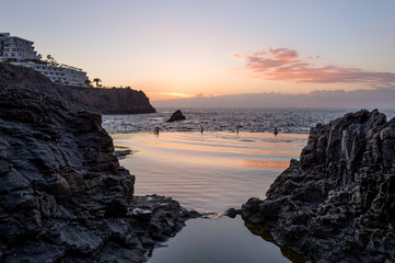 Fototapeta na wymiar Sunset at lava bassin - Piscina Naturale at Puerto Santiago. Tenerife island, Spain.