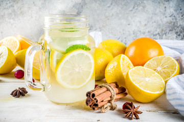 Set of various fall and winter refreshing infused water, sweet sour healthy beverages with oranges,...