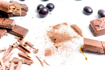 chocolate bar, shavings and cookies on a table