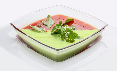 Spanish gazpacho soup. With tomatoes and cucumber in a glass dish on white background