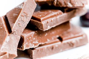 chocolate bar, shavings and cookies on a table