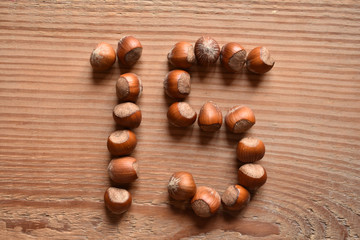 the number 15 shaped with hazelnuts