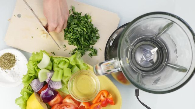 choping garlic with knife on a kitchen board for cooking healthy food. Top view 4K