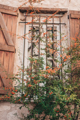 Old stone building with wooden shutters - Mediterranean architecture