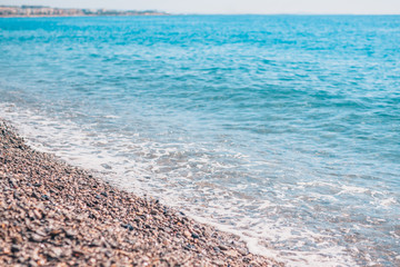 Cote d'Azur in the south of France - pebbles on the beach and sea wave - idyll