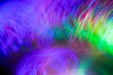 Defocused colored luminous spots and curved lines. For background