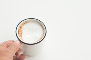 Close up a vintage cup of hot latte coffee on white vintage desk, coffee with milk