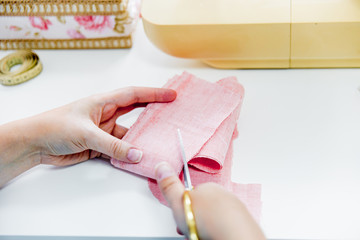 female hands are using a sewing machine