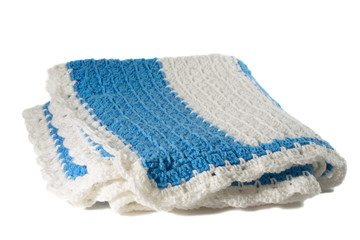 Handcrafted blue and white crochet afghan throw blanket isolated on a white background