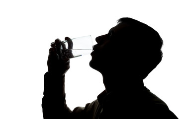 Young man drinks soda water - silhouette