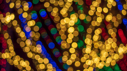 Background of colorful Christmas themed holiday light display with bokeh