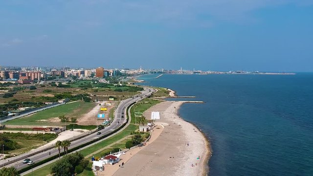View from above with a drone of the equipped beach of "Torre Quetta" in Bari. Visible skyline of the city of Bari.