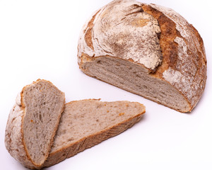 Loaf of organic farmer`s bread with slices, isolated on white background