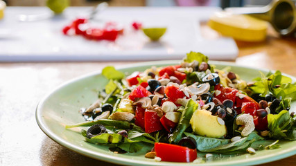 Preparation of healthy salad with herbs tomato and nuts