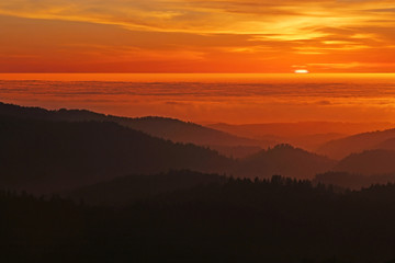 Coastal Californa Sunset over Mountains and Foggy Pacific Ocean