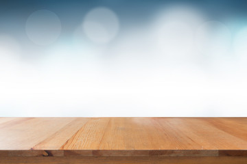 Empty of top wooden desk with blurred light blue gradient bokeh abstract background