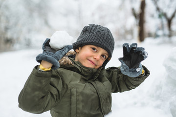 Fototapeta na wymiar boy making snowball outdoor