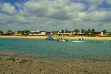 Boats with tourists on the beach of Barra de São Miguel
