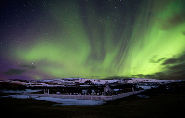 Northern Lights over Small Church in Iceland in Winter