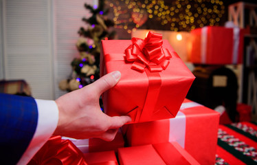 Magic moments. Prepare surprise gifts for family and friends. Prepare for christmas and new year. Gift boxes with big ribbon bow close up. Red wrapped gifts or presents. Wrapping gifts concept