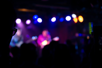 Silhouette of a concert crowd; The audience looks towards the stage; Party people at a rock concert