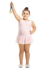 Little ballerina girl holding a gold medal